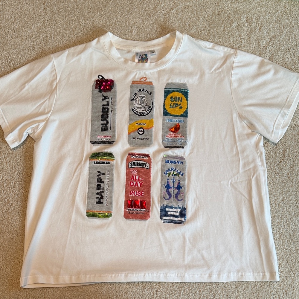 QUEEN OF SPARKLES Tops | White Graphic T-Shirt with Colorful Cans